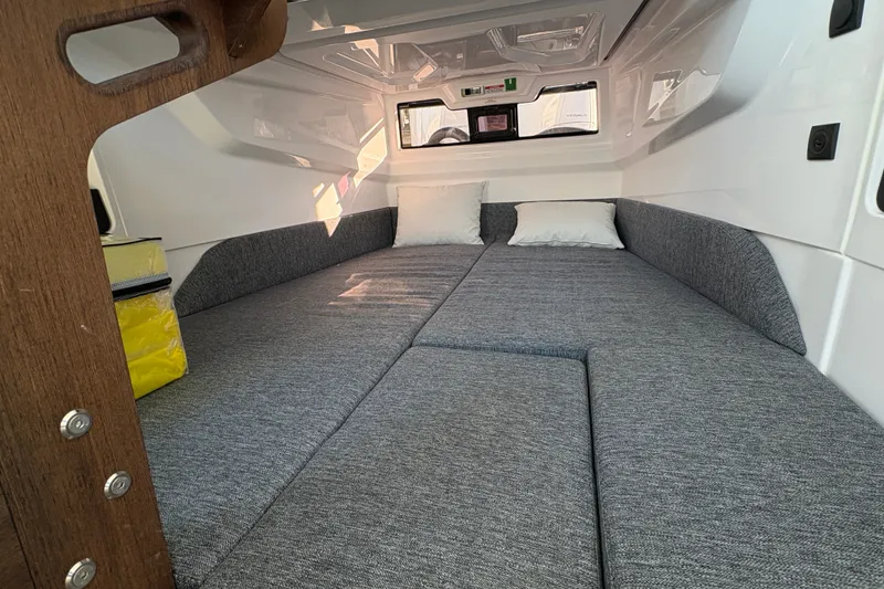 Slide: The Image of Cozy cabin interior of 2026 Axopar 29 XC Cross Cabin with gray upholstery. - 15