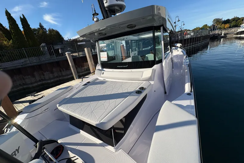 Slide: The Image of 2026 Axopar 29 XC Cross Cabin boat docked in a marina under clear skies. - 26