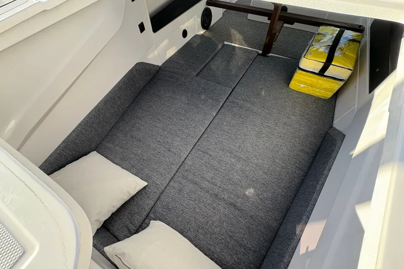 Slide: The Image of 2026 Axopar 29 XC Cross Cabin interior with gray cushions and pillows. - 24