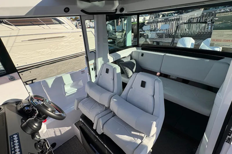 Slide: The Image of Interior of 2026 Axopar 29 XC Cross Cabin with modern seating and steering wheel. - 16