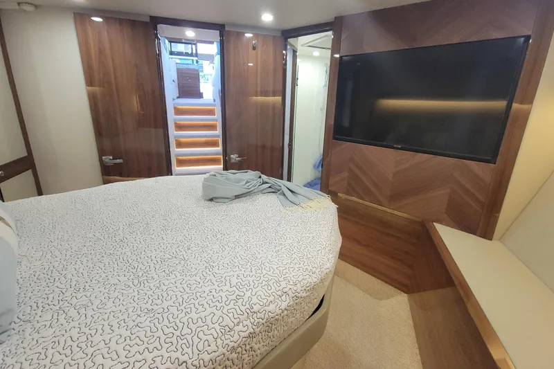 Slide: The Image of Luxurious bedroom interior of 2025 Maritimo M55 yacht with colorful pillows and cozy blanket. - 20