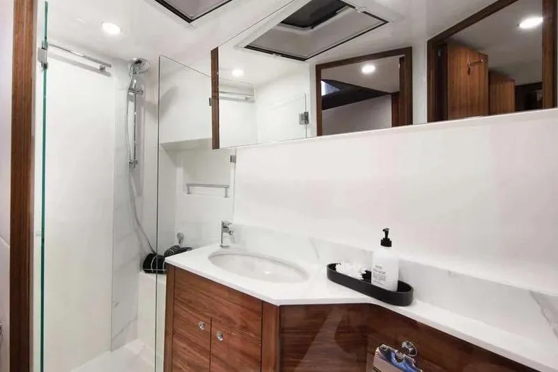 Slide: The Image of Luxurious bathroom in 2025 Maritimo M55 yacht, featuring elegant wood cabinetry and modern fixtures. - 29