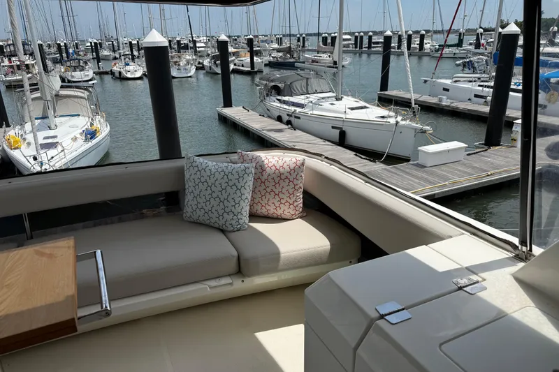 Slide: The Image of Luxurious 2025 Maritimo M55 yacht interior with marina view, featuring elegant seating and teak flooring. - 37