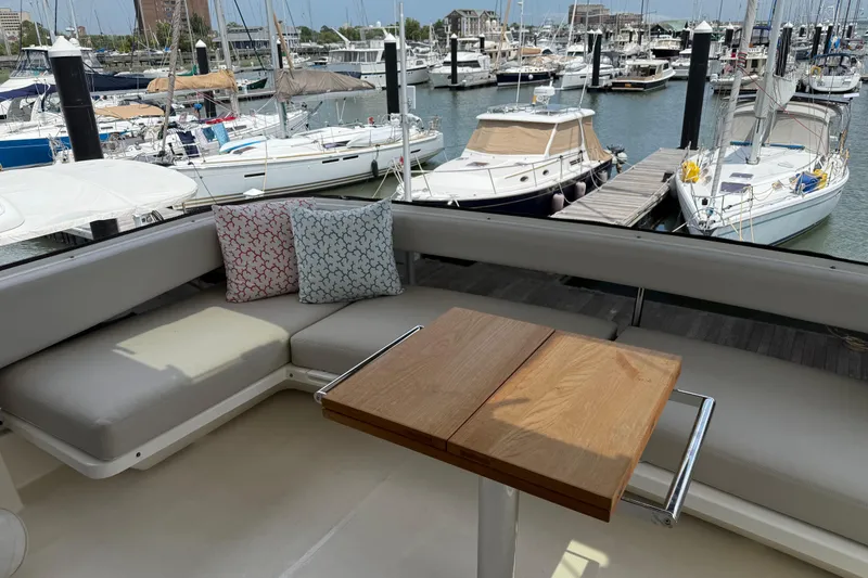 Slide: The Image of 2025 Maritimo M55 yacht docked, featuring sleek design and American flag. - 38