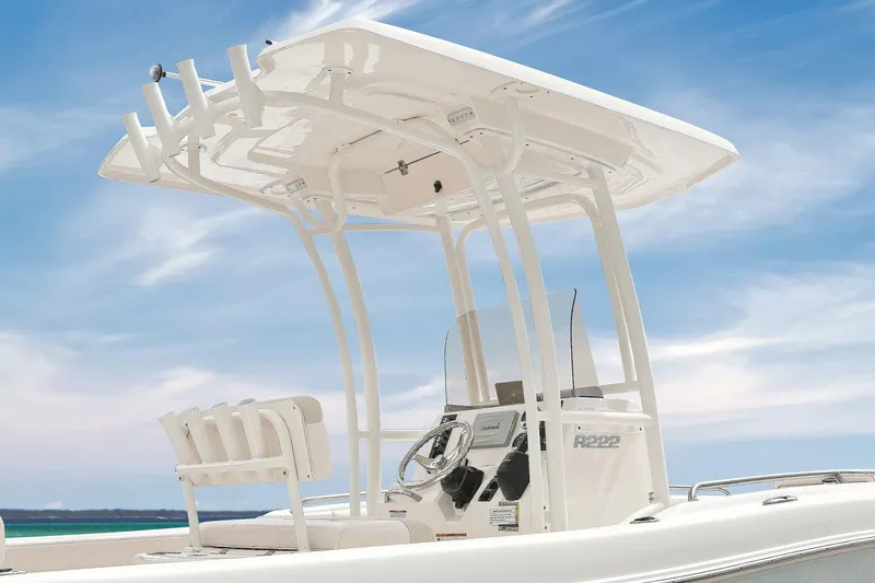 Slide: The Image of Manufacturer Provided Image: 2018 Robalo R222 Center Console boat with T-top against a blue sky. - 7