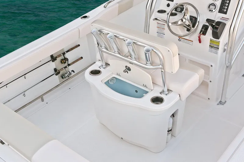 Slide: The Image of Manufacturer Provided Image: 2018 Robalo R222 Center Console boat interior with fishing rod holders and steering console. - 9