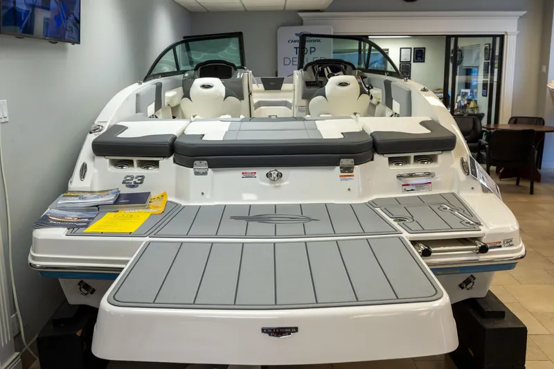 Slide: The Image of 2026 Chaparral 23 SSi boat displayed in showroom, featuring sleek design and spacious seating. - 15
