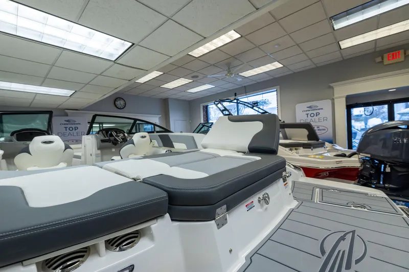 Slide: The Image of 2026 Chaparral 23 SSi boat interior in showroom, featuring sleek seating and modern design. - 18
