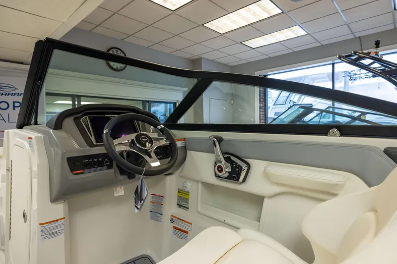 Slide: The Image of 2026 Chaparral 23 SSi boat interior with steering wheel and control panel. - 22