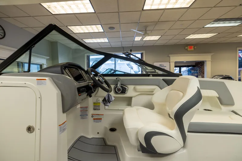 Slide: The Image of Interior view of 2026 Chaparral 23 SSi boat, featuring modern helm and seating. - 24