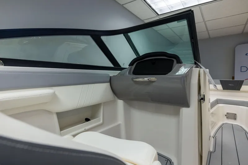 Slide: The Image of Interior view of 2026 Chaparral 23 SSi boat, featuring sleek design and modern dashboard. - 28