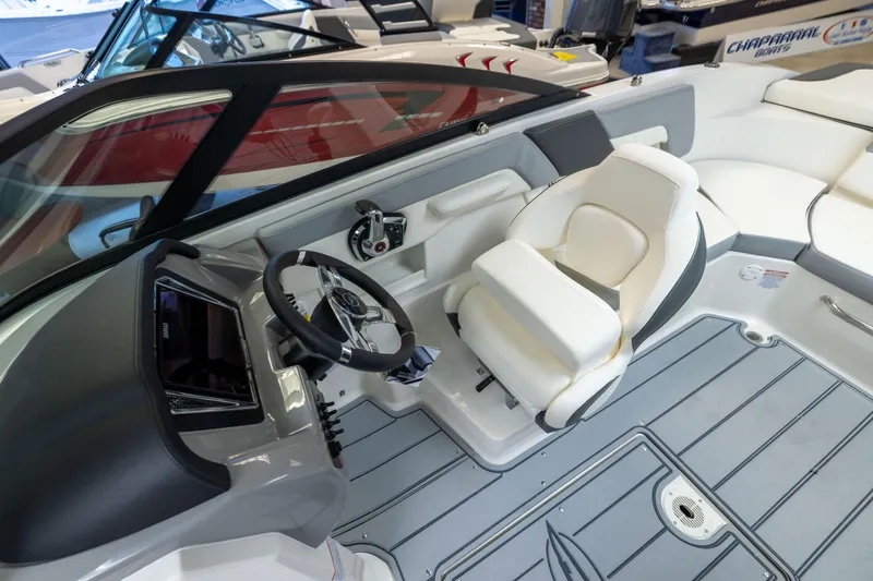 Slide: The Image of 2026 Chaparral 23 SSi boat interior with steering wheel and white seating. - 29