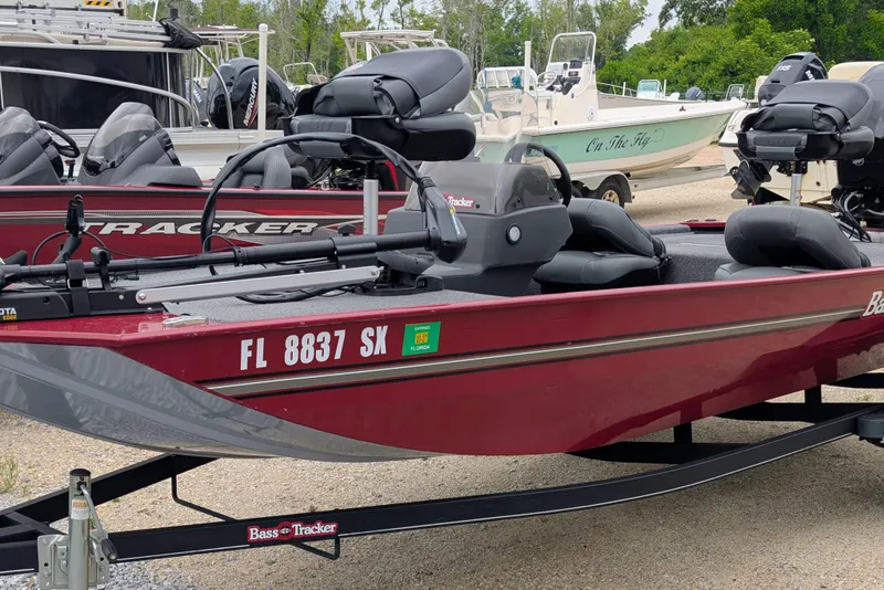 The Image of 2021 Tracker Bass Tracker Classic XL boat in a marina, featuring sleek design and comfortable seating. - 0