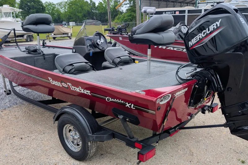 Slide: The Image of 2021 Tracker Bass Tracker Classic XL boat with Mercury engine, parked on a trailer. - 3