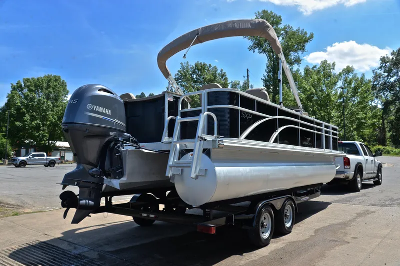 Slide: The Image of 2019 Bennington 22 pontoon boat with Yamaha motor on trailer, parked outdoors. - 14