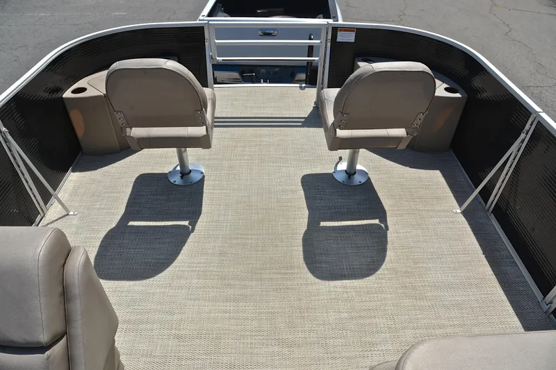 Slide: The Image of 2019 Bennington 22 pontoon boat interior with two swivel seats and carpeted deck. - 21