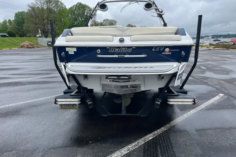 Slide: The Image of 2014 Malibu Wakesetter 23 LSV boat on trailer in parking lot. - 11