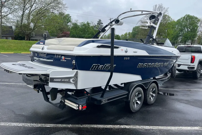 Slide: The Image of 2014 Malibu Wakesetter 23 LSV boat on trailer, parked outdoors on a cloudy day. - 12