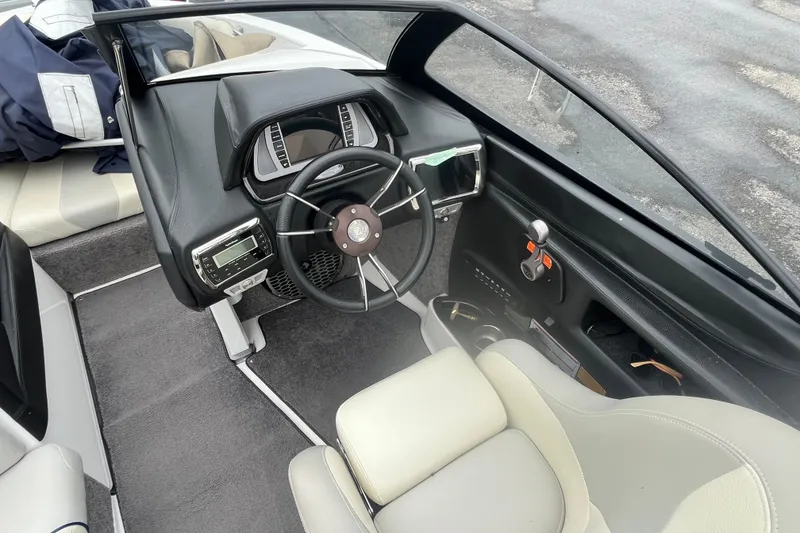 Slide: The Image of 2014 Malibu Wakesetter 23 LSV boat interior with steering wheel and dashboard controls. - 5