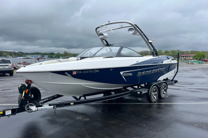 Slide: The Image of 2014 Malibu Wakesetter 23 LSV boat on trailer in parking lot. - 8