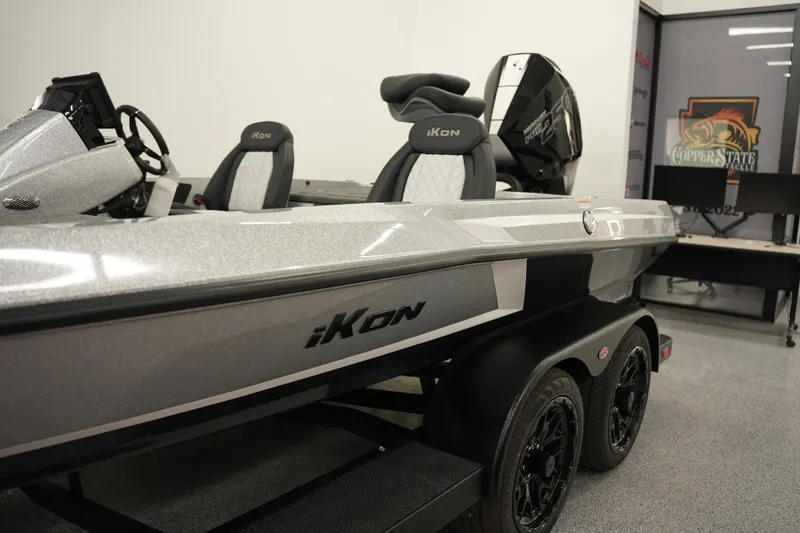 Slide: The Image of 2026 iKon LXE20 boat with sleek design and modern features in showroom setting. - 12