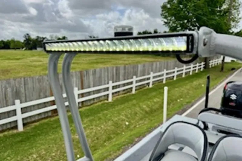 Slide: The Image of LED light bar on 2023 El Pescador 24 CAT boat, parked near a wooden fence. - 16