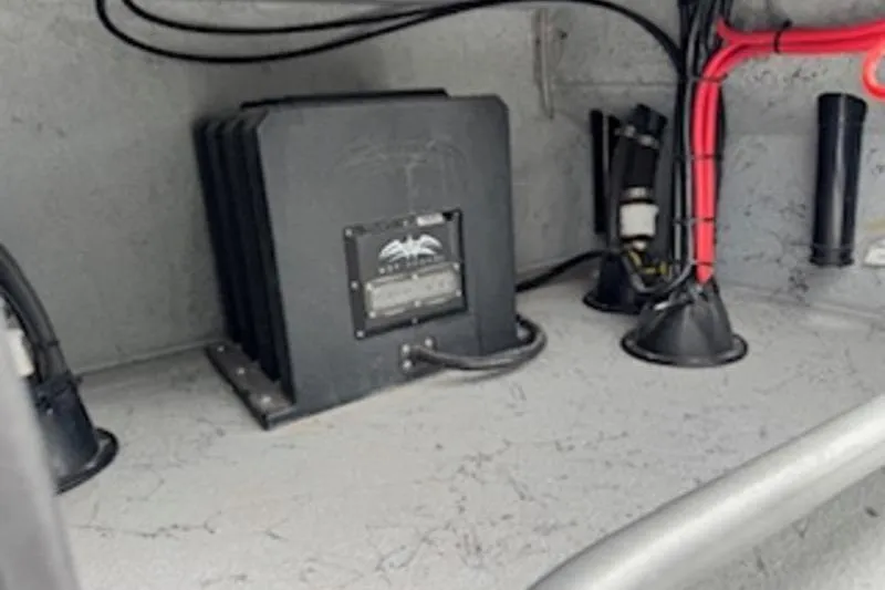 Slide: The Image of Electrical components inside a 2023 El Pescador 24 CAT boat, featuring wiring and equipment. - 17