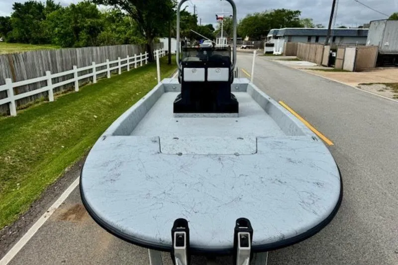 Slide: The Image of 2023 El Pescador 24 CAT boat on a road, showcasing its spacious deck. - 6