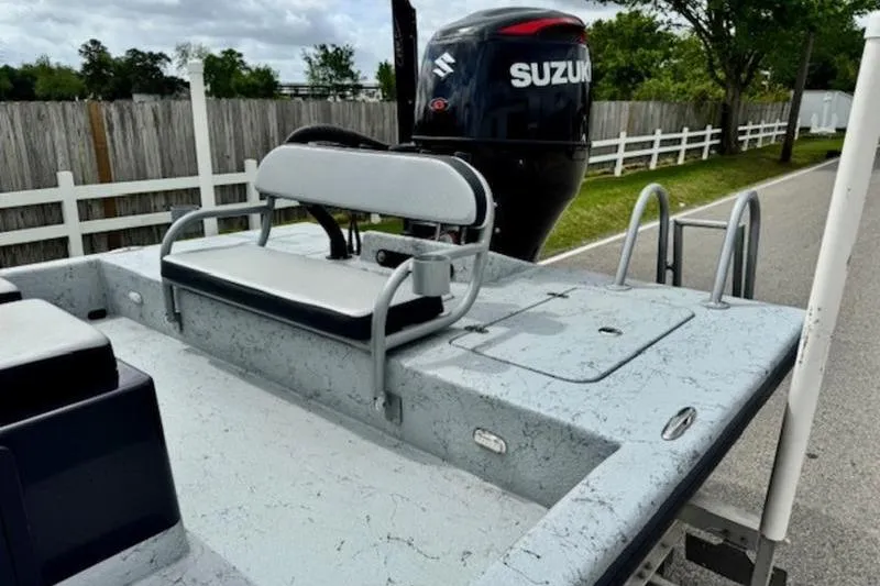Slide: The Image of 2023 El Pescador 24 CAT boat with Suzuki outboard motor, parked on a street. - 7