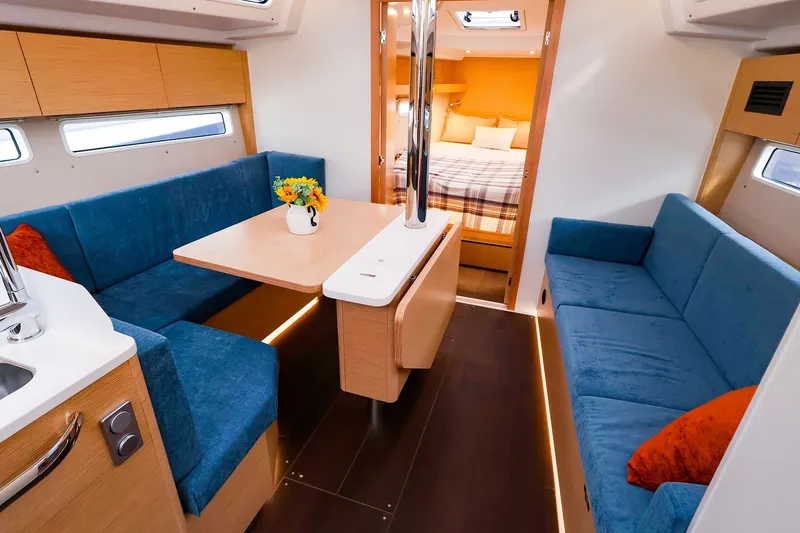 Slide: The Image of Modern interior of 2026 Hanse 360 yacht with blue seating and wooden accents. - 5