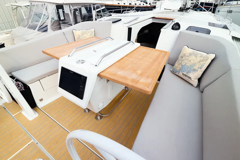 Slide: The Image of Modern 2026 Hanse 360 yacht cockpit with wooden table and cushioned seating. - 9