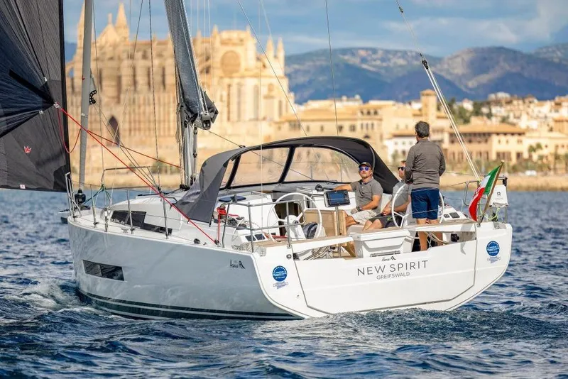 Slide: The Image of Hanse 360 sailboat, 2026 model, sailing near historic coastal backdrop. - 9