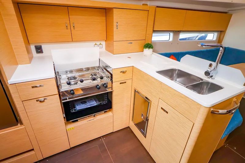 Slide: The Image of Modern kitchen interior of 2026 Hanse 360 yacht with stove, sink, and wooden cabinetry. - 4