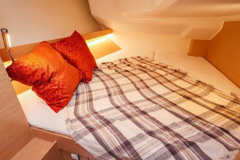 Slide: The Image of Cozy cabin bed in 2026 Hanse 360 yacht with plaid blanket and orange pillows. - 7