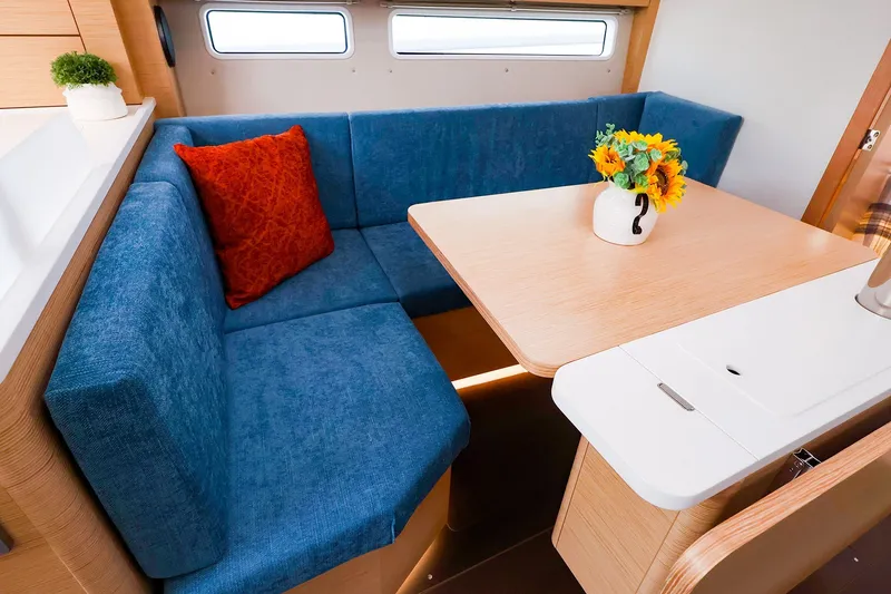 Slide: The Image of Cozy interior of 2026 Hanse 360 yacht with blue seating and wooden table. - 6