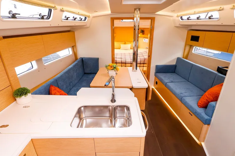 Slide: The Image of Modern interior of 2026 Hanse 360 yacht with blue seating and wooden finishes. - 2