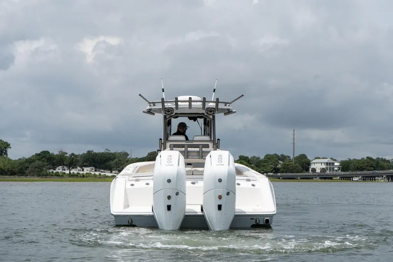 Slide: The Image of 2026 Solace 32CS boat with dual engines on a calm waterway. - 4