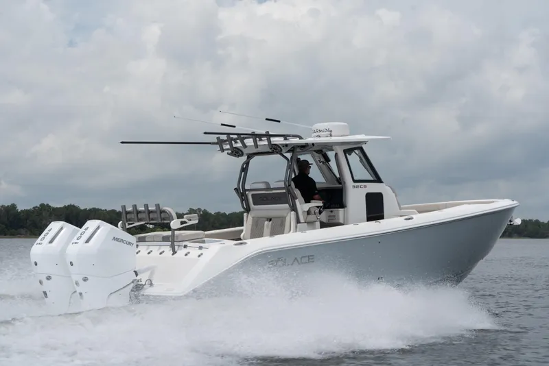 Slide: The Image of 2026 Solace 32CS boat cruising on water with dual Mercury engines. - 5