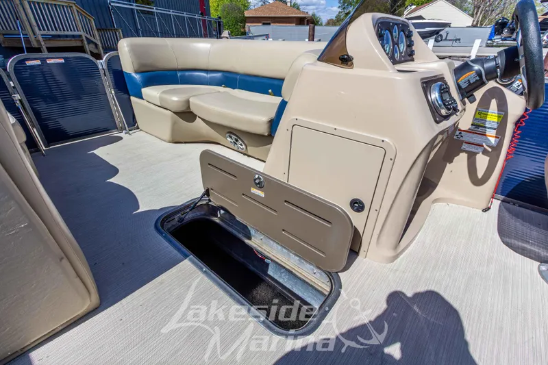 Slide: The Image of 2018 Manitou Aurora 23 LE RF VP boat interior with seating and storage compartment. - 10