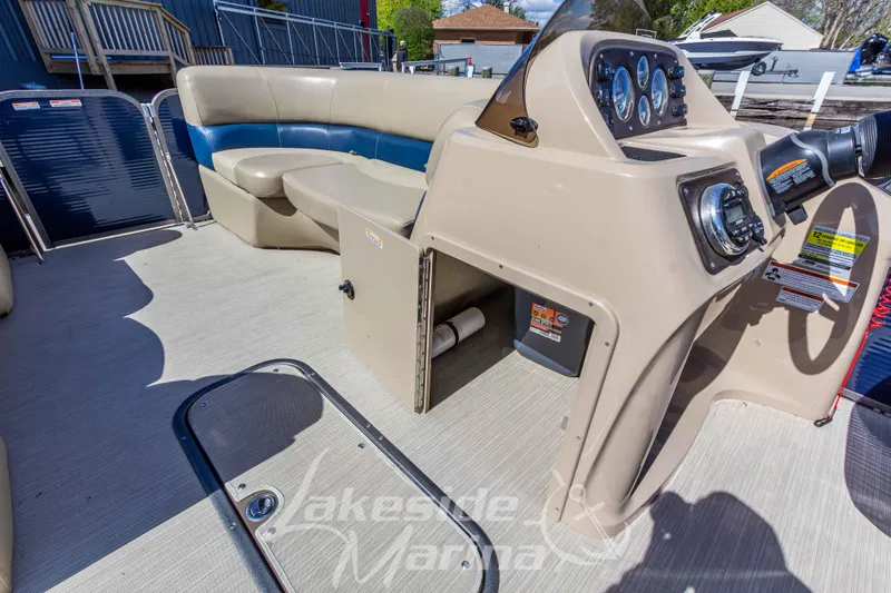 Slide: The Image of 2018 Manitou Aurora 23 LE RF VP pontoon boat interior with helm and seating area. - 11