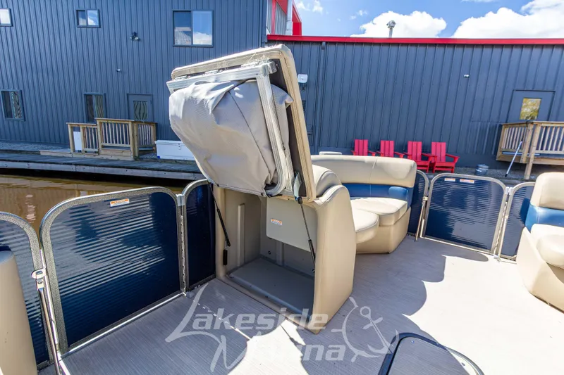 Slide: The Image of 2018 Manitou Aurora 23 LE RF VP pontoon boat interior with seating and storage. - 12
