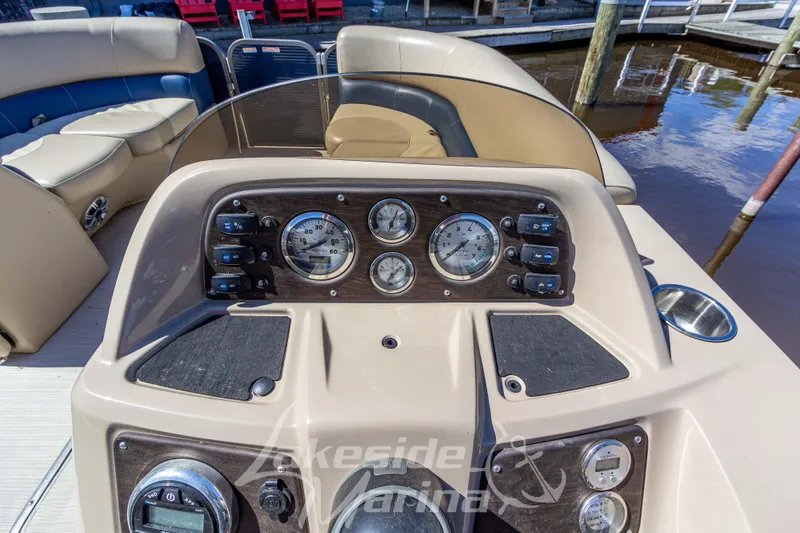 Slide: The Image of 2018 Manitou Aurora 23 LE RF VP boat dashboard with gauges and controls. - 15