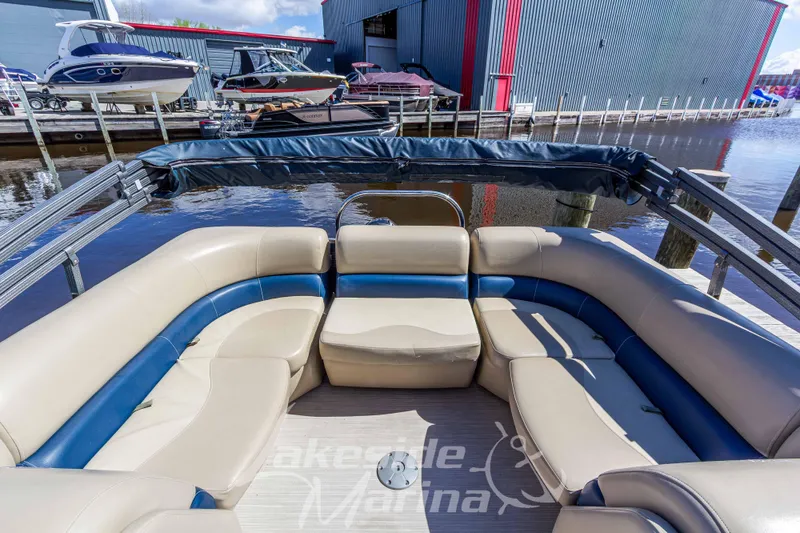 Slide: The Image of 2018 Manitou Aurora 23 LE RF VP pontoon boat with spacious seating at marina dock. - 16