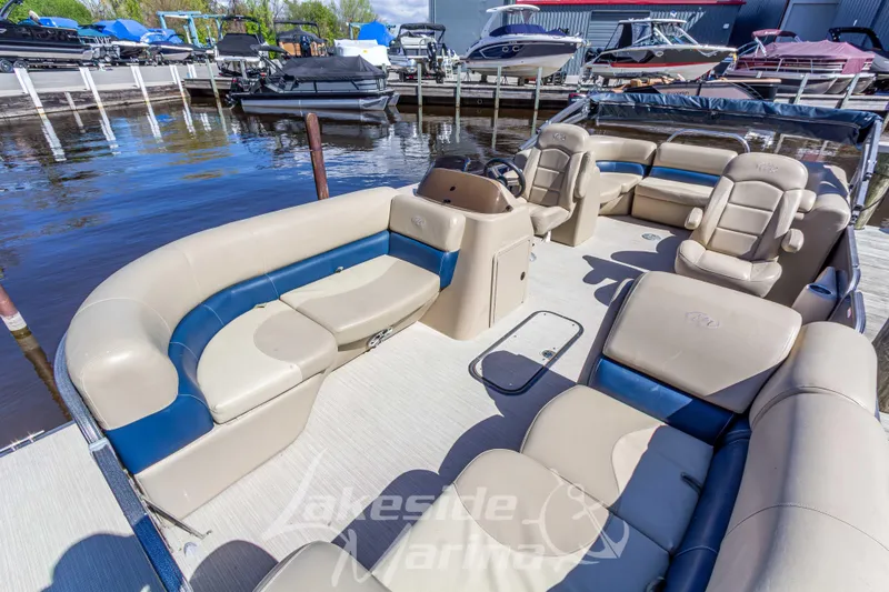 Slide: The Image of 2018 Manitou Aurora 23 LE RF VP pontoon boat with spacious seating at a marina. - 5