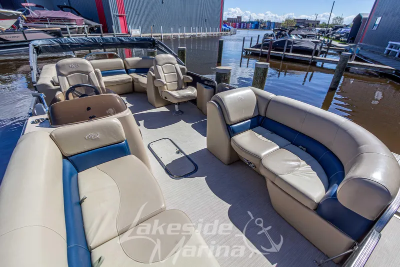 Slide: The Image of 2018 Manitou Aurora 23 LE RF VP pontoon boat with spacious seating at a marina. - 6