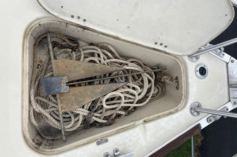 Slide: The Image of Anchor and ropes stored in a compartment of a 1988 Pearson 28 sailboat. - 12