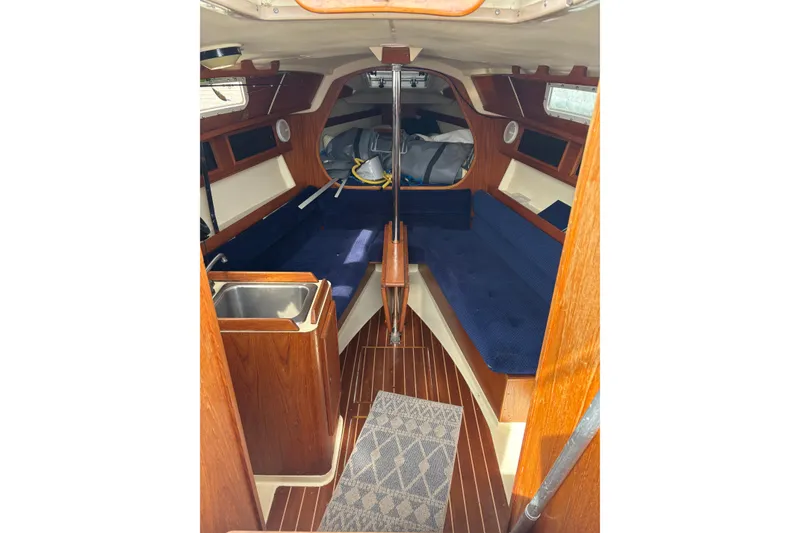 Slide: The Image of Interior of a 1988 Pearson 28 sailboat with wooden paneling and communication equipment. - 22