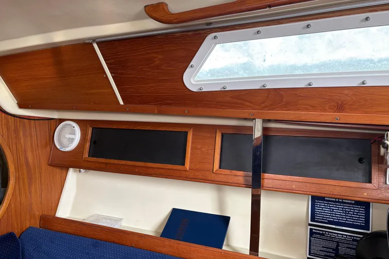 Slide: The Image of Interior view of a 1988 Pearson 28 sailboat hatch with wooden trim. - 25