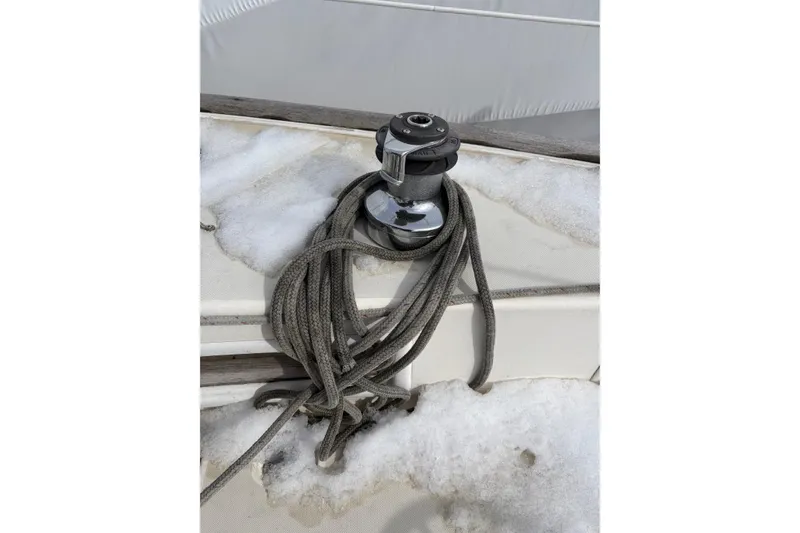 Slide: The Image of Winch and rope on snowy deck of 1988 Pearson 28 sailboat. - 11
