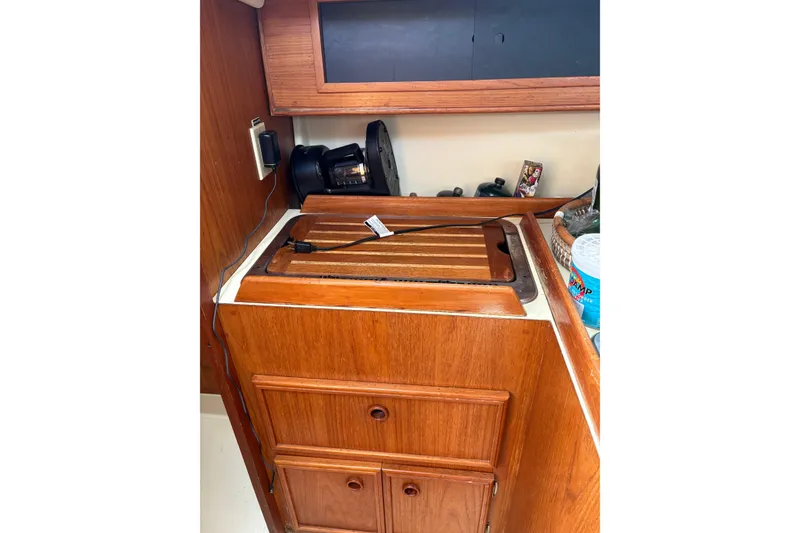 Slide: The Image of 1988 Pearson 28 yacht interior with wooden cabinetry and kitchen appliances. - 22